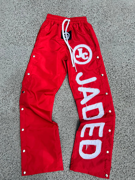 RED WINDBREAKER PANTS